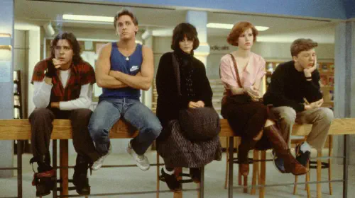assets/the-cast-of-the-breakfast-club-in-the-library.jpeg