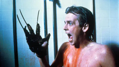 assets/a-young-man-screams-while-wearing-freddy-krueger-s-glover-in-a-nightmare-on-elm-street-2.jpeg