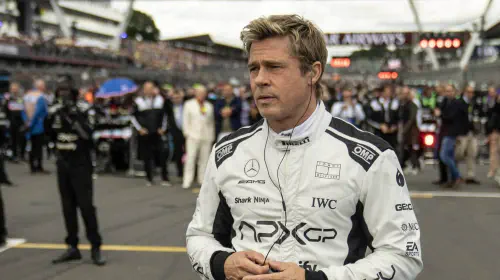 assets/brad-pitt-in-f1-wearing-his-uniform-standing-on-the-track-with-headphones-in.jpeg