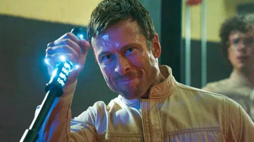 assets/glen-powell-holds-a-shiny-baton-in-2025-s-the-running-man.jpeg