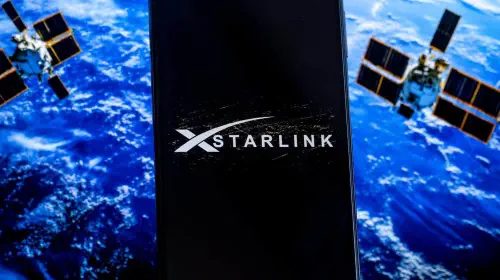 assets/Starlink-logo-on-a-screen-with-planet-and-satellites-in-background-1.jpeg
