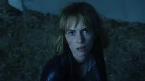 assets/maya-hawke-s-robin-stares-at-the-camera-in-stranger-things-season-5-trailer.jpeg