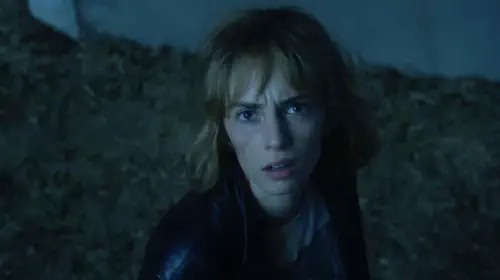 assets/maya-hawke-s-robin-stares-at-the-camera-in-stranger-things-season-5-trailer.jpeg