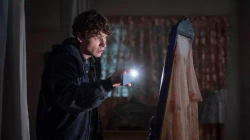 assets/nicholas-denton-in-talamasca-the-secret-order-using-his-flashlight-looking-at-a-mirror.jpeg
