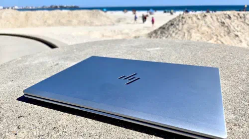 assets/HP-EliteBook-6-G1q-closed-at-the-beach-1.jpeg