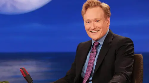 assets/conan-o-brien-sitting-behind-his-late-night-desk.jpeg