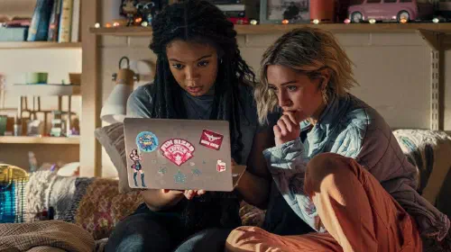 assets/marie-and-emma-looking-at-a-laptop-in-gen-v.jpeg