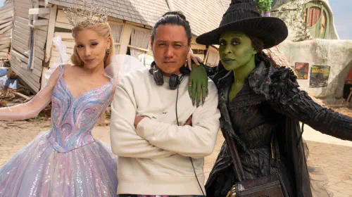 assets/ariana-grande-and-cynthia-erivo-posing-with-jon-m-chu-on-the-set-of-wicked-for-good.jpeg