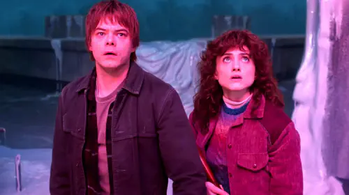 assets/charlie-heaton-s-jonathon-and-natalia-dyer-s-nancy-looking-worried-at-something-while-in-the-upside-down-in-stranger-things-season-5.jpeg