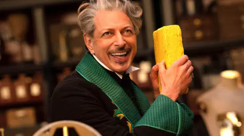 assets/jeff-goldblum-as-the-wizard-holding-a-yellow-brick-in-wicked-for-good.jpeg