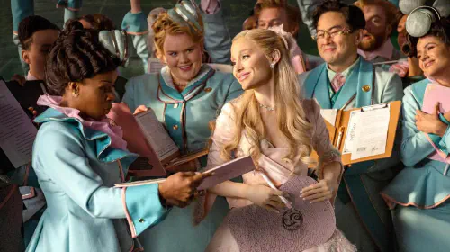 assets/glinda-smiling-as-she-is-surrounded-by-adoring-attendants-in-wicked-for-good.jpeg