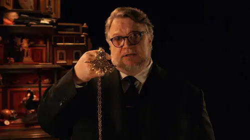 assets/guillermo-del-toro-presenting-a-necklace-in-cabinet-of-curiosities.jpeg