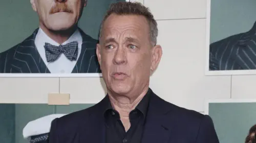 assets/tom-hanks-pulls-a-face-at-a-red-carpet-event.jpeg