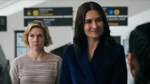 assets/rhea-seehorn-s-carol-looking-distracted-and-karolina-wydra-s-zosia-smiling-at-someone-in-pluribus.jpeg