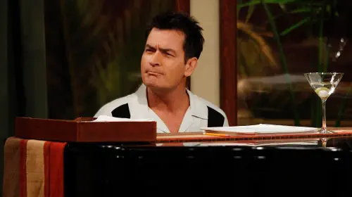 assets/charlie-sheen-sitting-behind-a-piano-on-two-and-a-half-men.jpeg