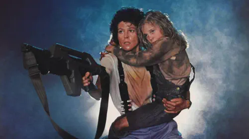 assets/sigourney-weaver-holds-a-child-and-points-a-gun-in-aliens.jpeg