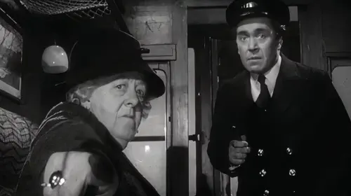 assets/miss-marple-pointing-at-something-off-screen-to-a-train-conductor-while-riding-a-train-in-murder-she-said.jpeg