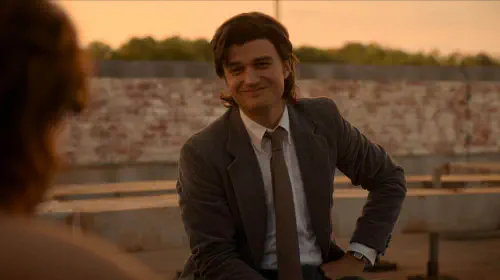 assets/steve-in-a-suit-smiling-at-nancy-in-stranger-things-season-5-episode-8.jpeg