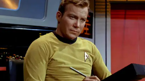 assets/william-shatner-as-captain-kirk-writing-on-his-pad-in-star-trek-the-original-series.jpeg