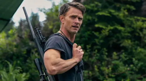assets/wilson-bethel-carrying-a-firearm-over-his-shoulder-and-looking-to-the-side-in-untamed.jpeg