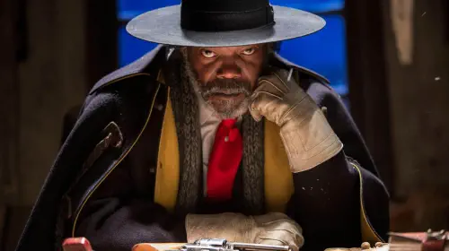 assets/samuel-l-jackson-s-warren-looking-intensely-toward-the-camera-while-sitting-a-table-with-a-revolver-in-front-of-him-in-the-hateful-eight.jpeg
