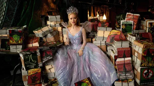 assets/a-dismayed-glinda-sitting-in-a-pile-of-anti-elphaba-propaganda-in-wicked-for-good.jpeg