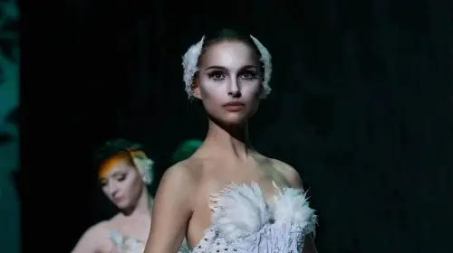 assets/natalie-portman-in-a-still-from-black-swan-wearing-a-white-dress-staring-directly-ahead-of-her-1.jpeg
