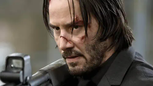 assets/keanu-reeves-holding-shotgun-in-john-wick.jpeg