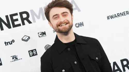 assets/daniel-radcliffe-smiling-while-on-the-warnermedia-red-carpet.jpeg