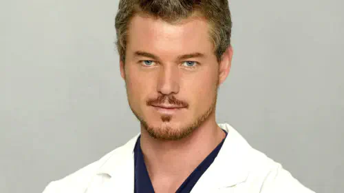 assets/eric-dane-as-mark-sloan-wearing-his-doctor-s-coat-in-a-grey-s-anatomy-promotional-image.jpeg