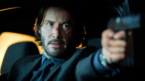 assets/keanu-reeves-holding-a-gun-in-a-car-in-john-wick.jpeg