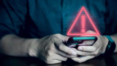 assets/Man-on-phone-with-security-alert-warning.jpeg