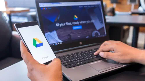 assets/Google-Drive-on-phone-in-hand-and-on-laptop-on-desk.jpeg