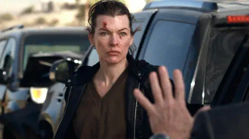 assets/milla-jovovich-s-nikki-looking-angrily-at-someone-standing-next-to-a-truck-in-protector.jpeg