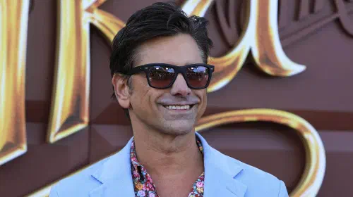 assets/john-stamos-smiling-at-wonka-premiere.jpeg