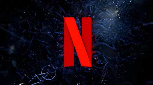 assets/the-netflix-logo-stands-in-the-middle-of-the-screen-surrounded-by-stranger-things-tree-roots-and-bycicles.jpeg