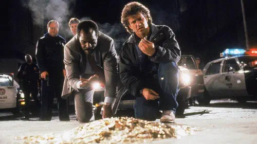 assets/riggs-and-murtaugh-investigating-coins-in-lethal-weapon-2.jpeg