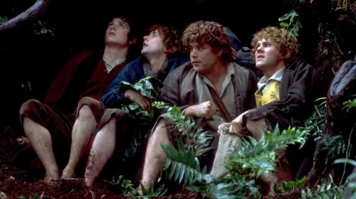 assets/merry-sam-pippin-and-frodo-hiding-beneath-a-tree-in-the-lord-of-the-rings-the-fellowship-of-the-ring.jpeg