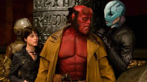 assets/ron-perlman-and-selma-blair-talking-to-an-alien-like-creature-in-hellboy-ii.jpeg