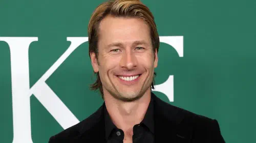 assets/glen-powell-smiling-on-the-red-carpet-for-how-to-make-a-killing.jpeg