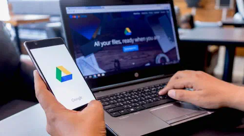 assets/Google-Drive-on-phone-and-laptop-with-user-using-it.jpeg