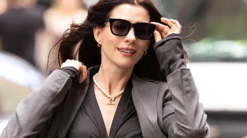 assets/anne-hathaway-adjusting-her-glasses-while-crossing-a-street-behind-the-scenes-on-the-devil-wears-prada-2.jpeg
