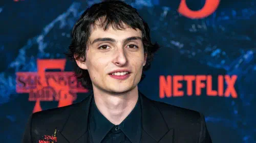 assets/finn-wolfhard-smiling-while-on-the-stranger-things-season-5-red-carpet.jpeg