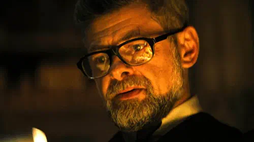 assets/andy-serkis-alfred-looking-intently-while-holding-something-in-the-batman.jpeg