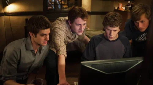 assets/university-students-looking-at-a-computer-screen-in-the-film-the-social-network.jpeg