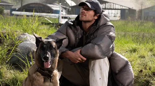 assets/jacob-elordi-s-hig-sitting-next-to-his-dog-while-looking-at-the-sky-in-the-dog-stars.jpeg