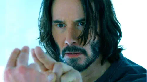 assets/keanu-reeves-as-neo-holding-two-fingers-up-to-a-mirror-in-the-matrix-resurrections.jpeg