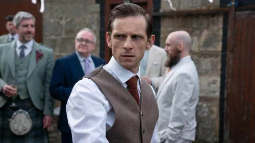 assets/jamie-bell-looking-worried-over-his-shoulder-in-half-man.jpeg
