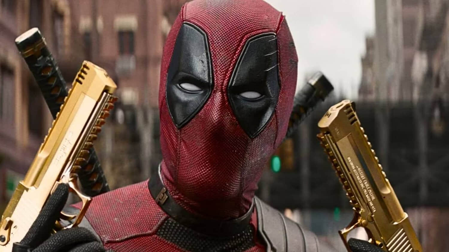ryan-reynolds-as-deadpool-with-gold-pistols-in-deadpool-wolverine.jpeg