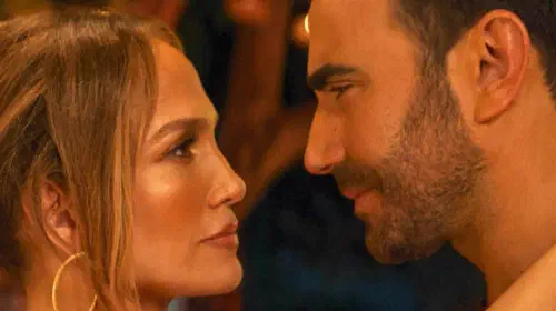 assets/jennifer-lopez-and-brett-goldstein-facing-each-other-in-office-romance.jpeg